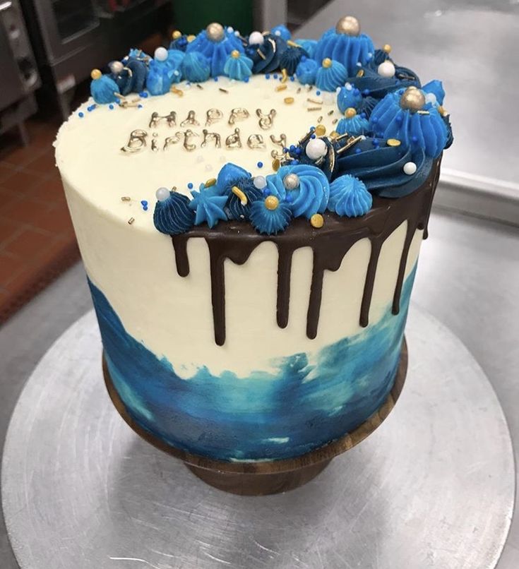 a birthday cake with blue and white frosting