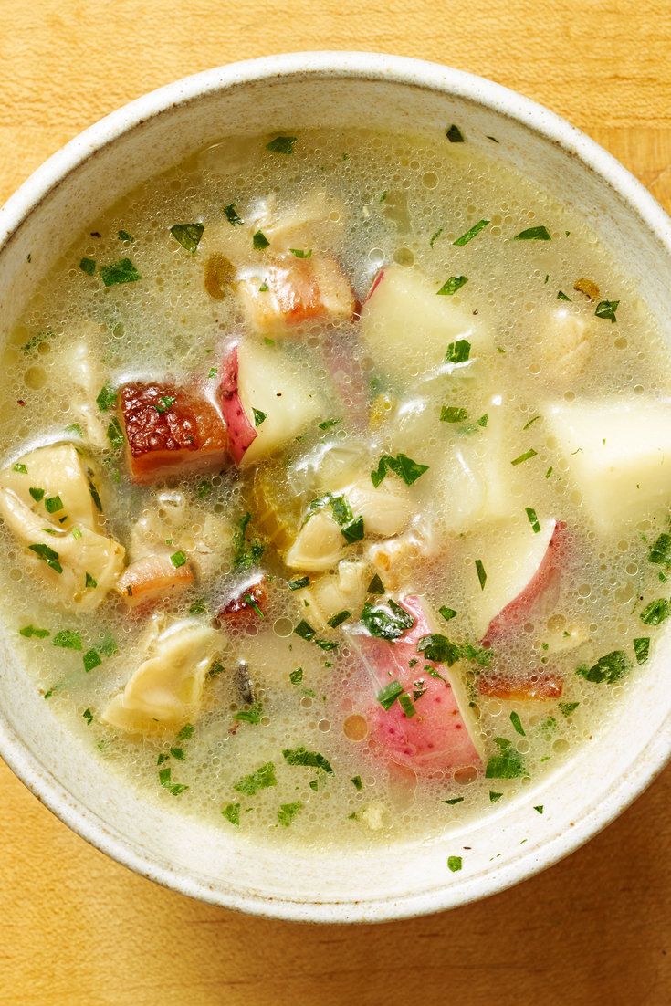 a white bowl filled with soup on top of a wooden table