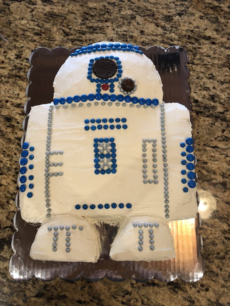 a cake shaped like a robot sitting on top of a counter