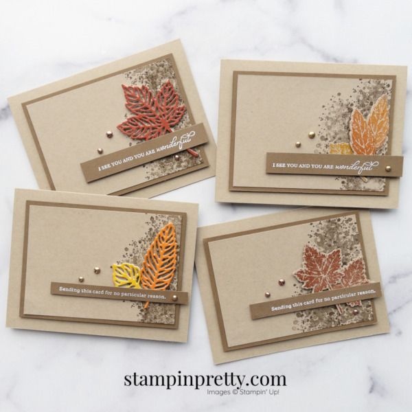 three cards with leaves on them sitting next to each other