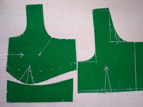 two pieces of green fabric that have been cut out to look like they are being used for sewing