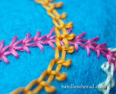 a close up view of the stitching and crochet work on a piece of fabric