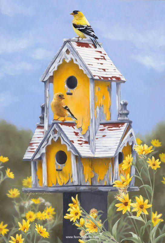 a yellow birdhouse with two birds on it's roof and flowers in the foreground