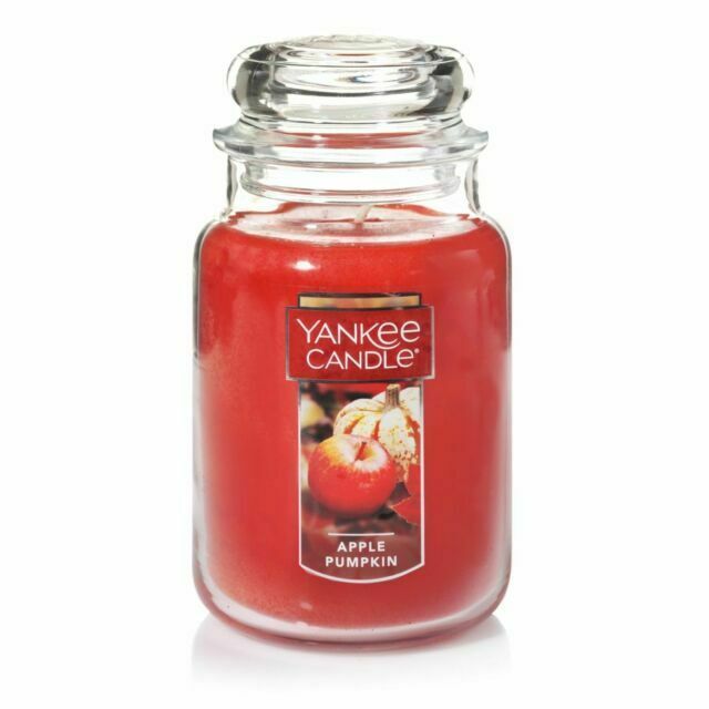 an apple cinnamon yankee candle in a glass jar on a white background with clipping for text