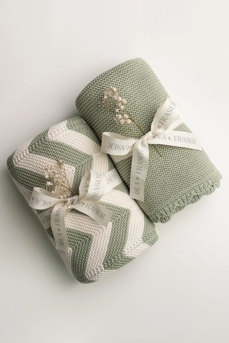 three green and white towels wrapped in ribbon