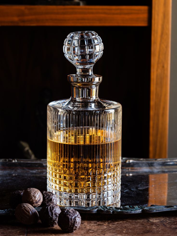 an empty glass bottle sitting on top of a table