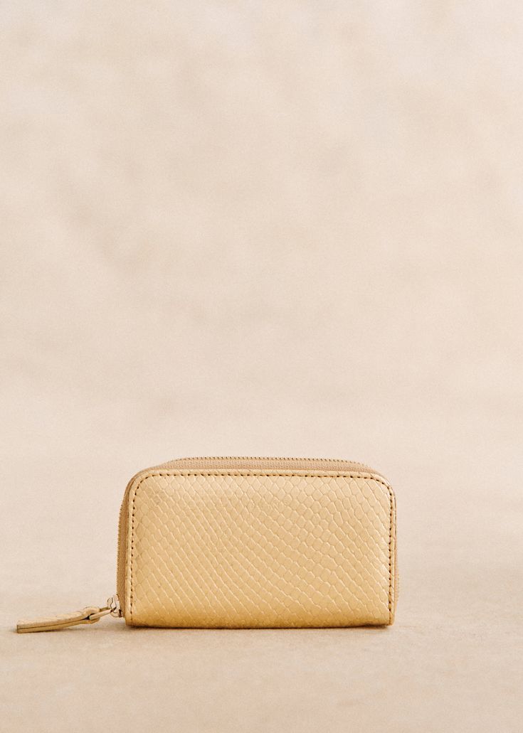 Made in our Portuguese atelier;Embossed metallic leather exterior;Textile lining;Light gold metallic zip fastening;Credit card holder. Zipped pocket.;Weight: 85 g / 3 oz;Dimensions: 6 x 2.5 x 11 cm / 2.4 x 1 x 4.3 in Luxury Gold Coin Purse With Card Slots, Compact Gold Wallet For Formal Occasions, Formal Gold Coin Purse With Card Slots, Formal Compact Gold Wallet, Formal Gold Compact Wallet, Luxury Gold Wallet With Interior Card Slots, Luxury Gold Wallets With Card Slots, Gold Luxury Wallets With Card Slots, Compact Gold Coin Purse With Card Slots