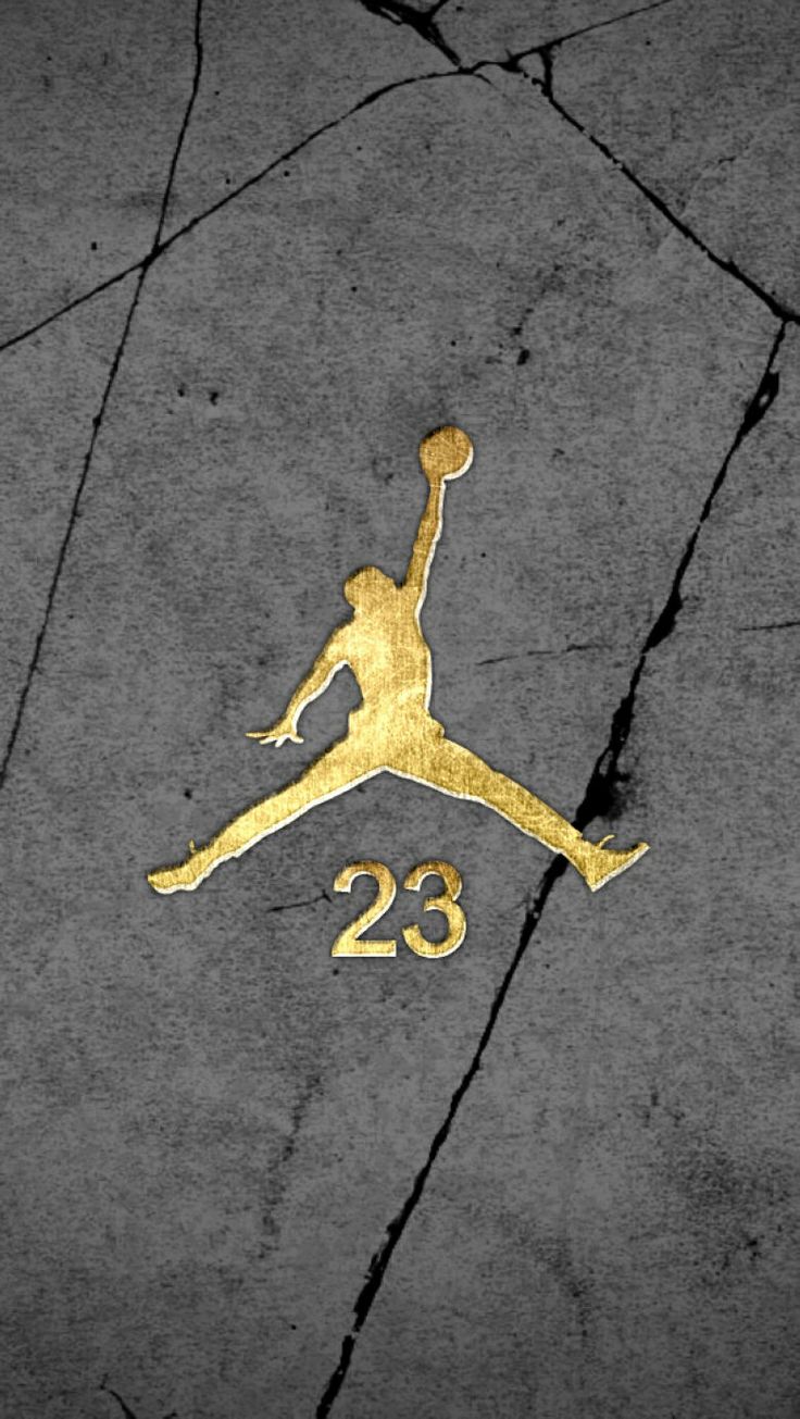 the air jordan 23 logo is painted on concrete with gold paint and it looks like he's about to jump