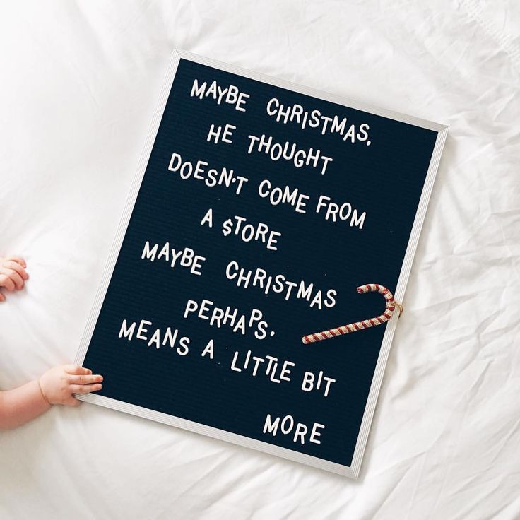 a child holding a sign that says maybe christmas he thought doesn't come from a store