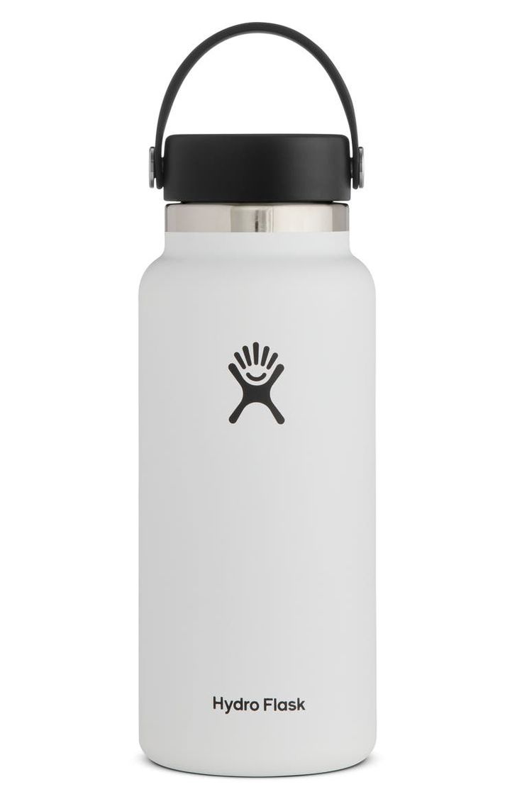 the hydro flask water bottle in white with black lid and handle is shown on a white background