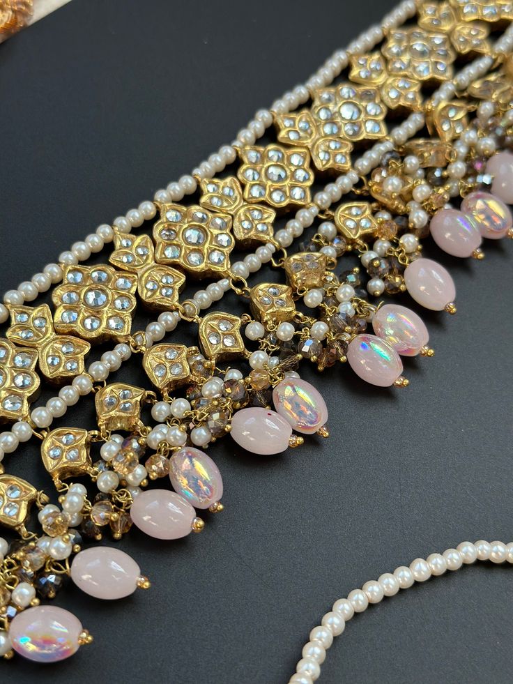 This lightweight and dainty set in thapa kundan or multani work is made of high quality gold plating and has gorgeous pink crystal drops that have an ombre finish. The colors are super unique and pastel so that they can go with any outfit whether its a saree or lehenga! and can be worn separately for a simple look. This lightweight and elegant necklace is perfect for any bridesmaid, bride, sangeet or any occasion or event as a gift for any occasion as any one who loves jewelry will love this sta Bollywood Style Pink Traditional Wear With Kundan, Gold Jewelry Sets With Gota Work For Festive Occasions, Festive Gold Jewelry Sets With Gota Work, Elegant Pink Kundan Jewelry Sets, Elegant Pink Kundan Sets, Bollywood Style Gold Jewelry Sets With Gota Work, Pink Tilla Necklaces For Diwali, Pink Necklaces With Tilla For Diwali, Pink Tilla Necklace For Diwali