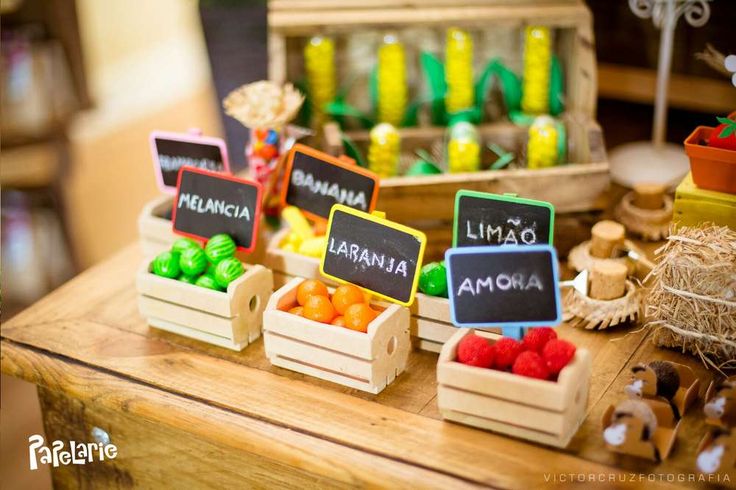 small wooden boxes filled with different types of fruit on top of a table next to other items