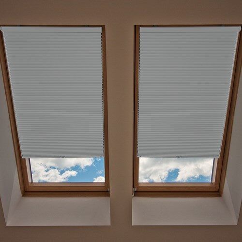 two windows with skylights in the middle of them and one window is closed to let light into the room