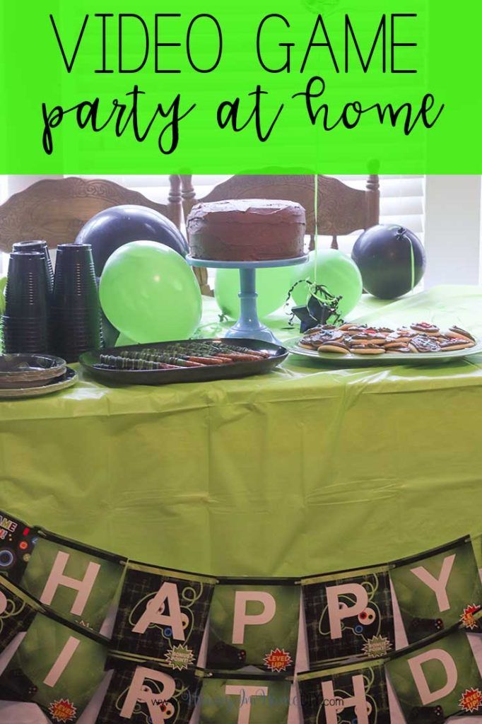 a video game party at home with green table cloths and black plates on the table