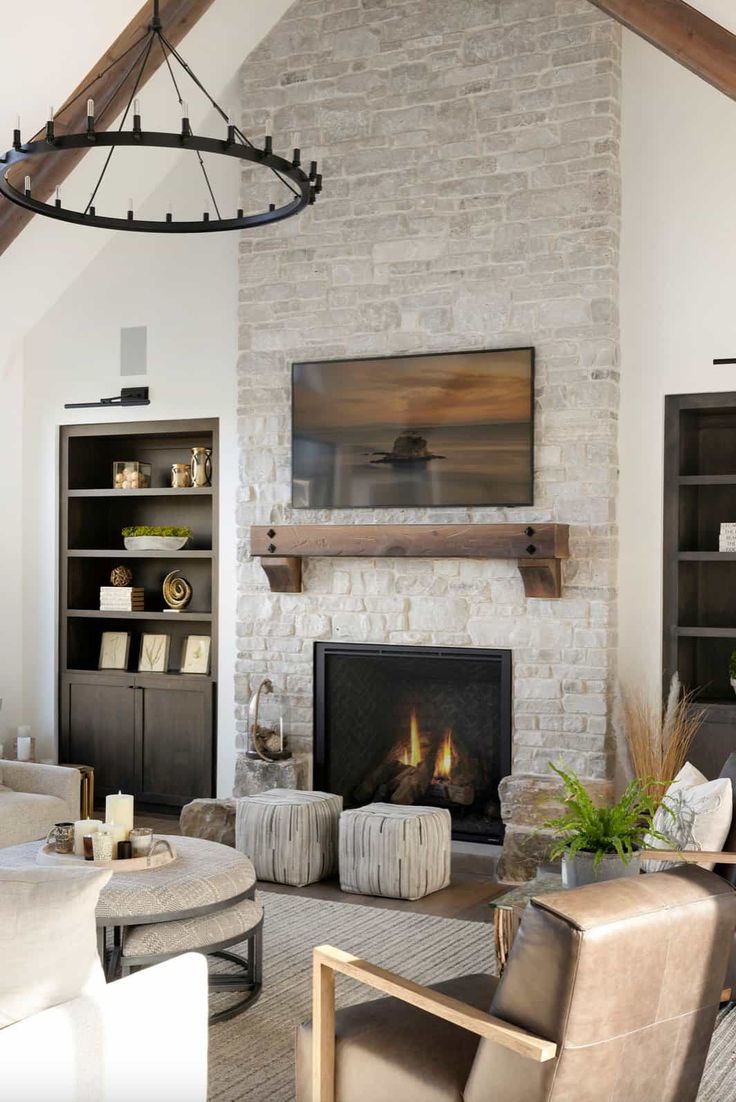 a living room filled with furniture and a fire place in front of a stone fireplace