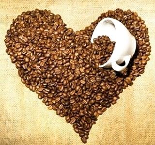 a heart made out of coffee beans with a spoon