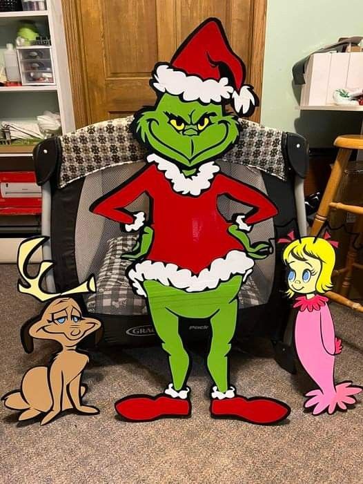 the grinch is standing next to an empty chair