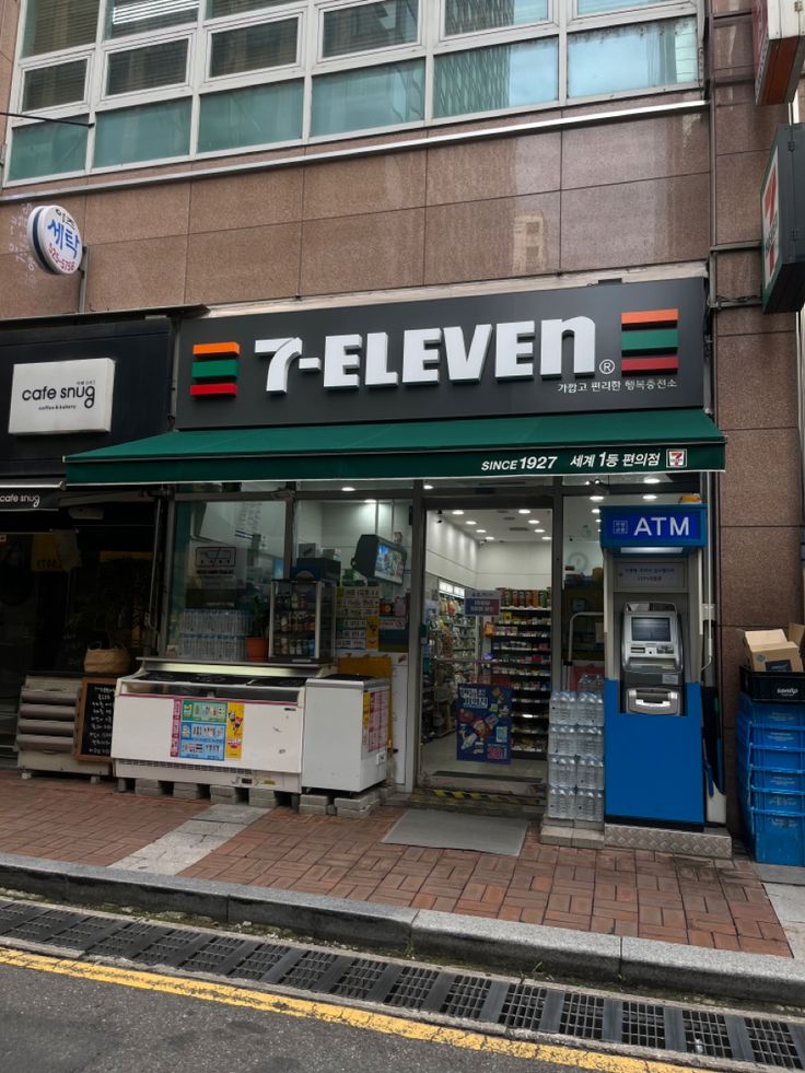 a store front with an atm on the sidewalk