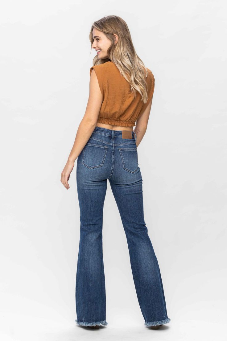 Get ready to rock these HIGH WAIST TUMMY CONTROL FRAY HEM FLARE jeans from Judy Blue! With its flattering high waist and tummy control feature, you'll feel confident and comfortable all day long. Plus, the ultra-stylish fray hem adds a touch of unique flair to your wardrobe. Who says control can't be fun? 88681 REG Judy Blue 91% Cotton / 7% Polyester / 2% SpandexFRONT RISE: 11"INSEAM: 33.5" Fitted Mid-rise Medium Wash Pants, Medium Wash Fitted Wide Leg Bottoms, Medium Wash Stretch Mid-rise Bottoms, Medium Wash Fitted Mid-rise Bottoms, Fitted High Rise Denim Blue Bottoms, Fitted Mid-rise Medium Wash Bottoms, Fitted Denim Bottoms With Elastic Waistband, Fitted High Waist Medium Wash Bottoms, Denim Blue Mid-rise Tops For Fall