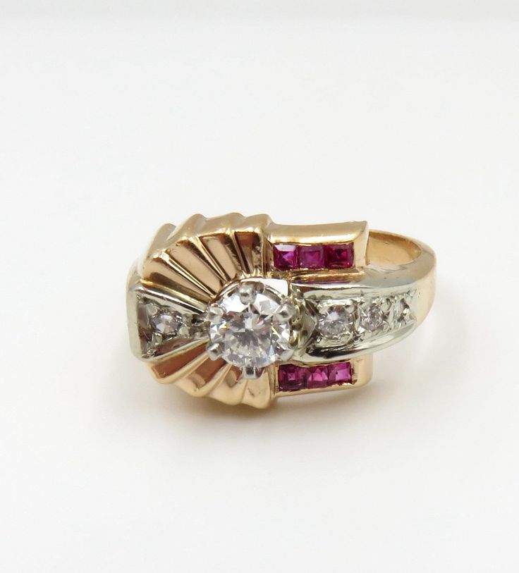 Circa 1940. Lovely Retro 14kt gold ring with a nice rose glow, features a platinum prong set, Round Brilliant cut diamond; I1 clarity and F color. Accenting the central diamond are 4 round brilliant cut diamonds and 6 Square Step Cut Rubies. This very pretty retro ring has such a great sparkle and would be an amazing alternative engagement ring. It is approximately size 6 3/4 and could be sized. The Independent Written appraisal (GG/GIA) has been photographed (Last two photos). Appraisal Value: Vintage White Ruby Ring For Anniversary, Classic White Ruby Ring With Vvs Clarity, Classic Ruby Ring With Vvs Clarity Diamond, White Ruby Ring With Brilliant Cut For Formal Events, White Ruby Ring With Brilliant Cut For Formal Occasions, White Ruby Ring With Prong Setting For Formal Occasions, Formal White Ruby Ring With Brilliant Cut, Formal White Ruby Ring With Diamond, Classic White Diamond Ruby Ring