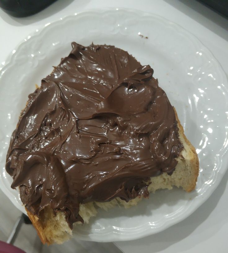 a piece of bread with chocolate frosting on it