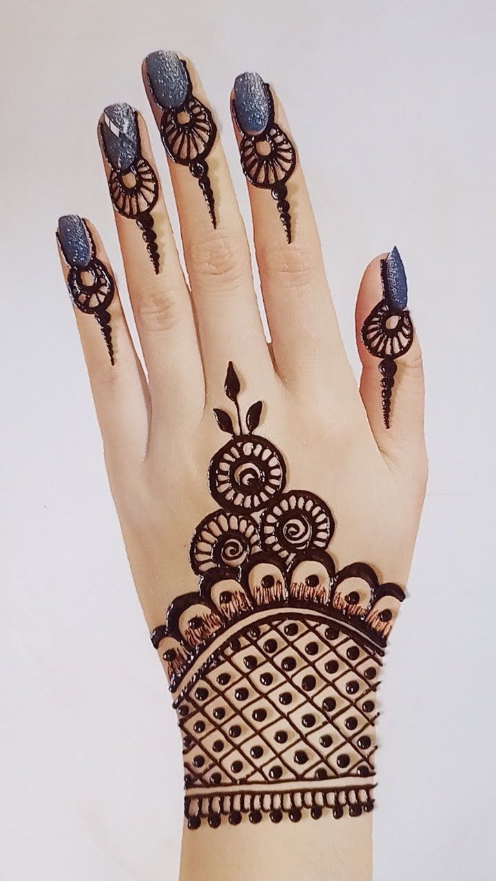 a woman's hand with henna tattoos on it