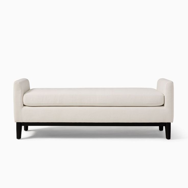 a white couch sitting on top of a wooden frame