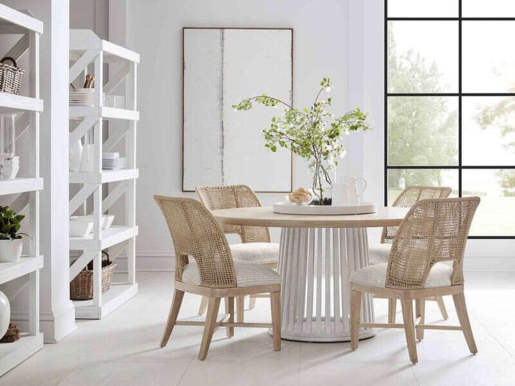 a dining room table with four chairs around it