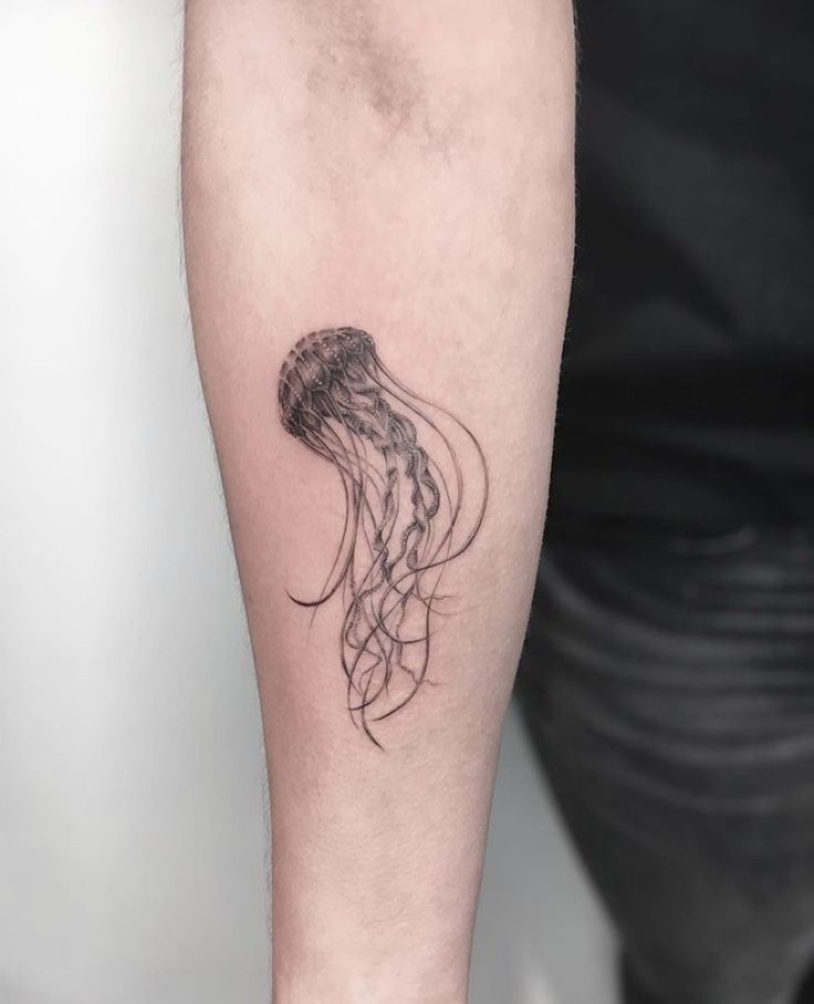 a black and white photo of a jellyfish tattoo