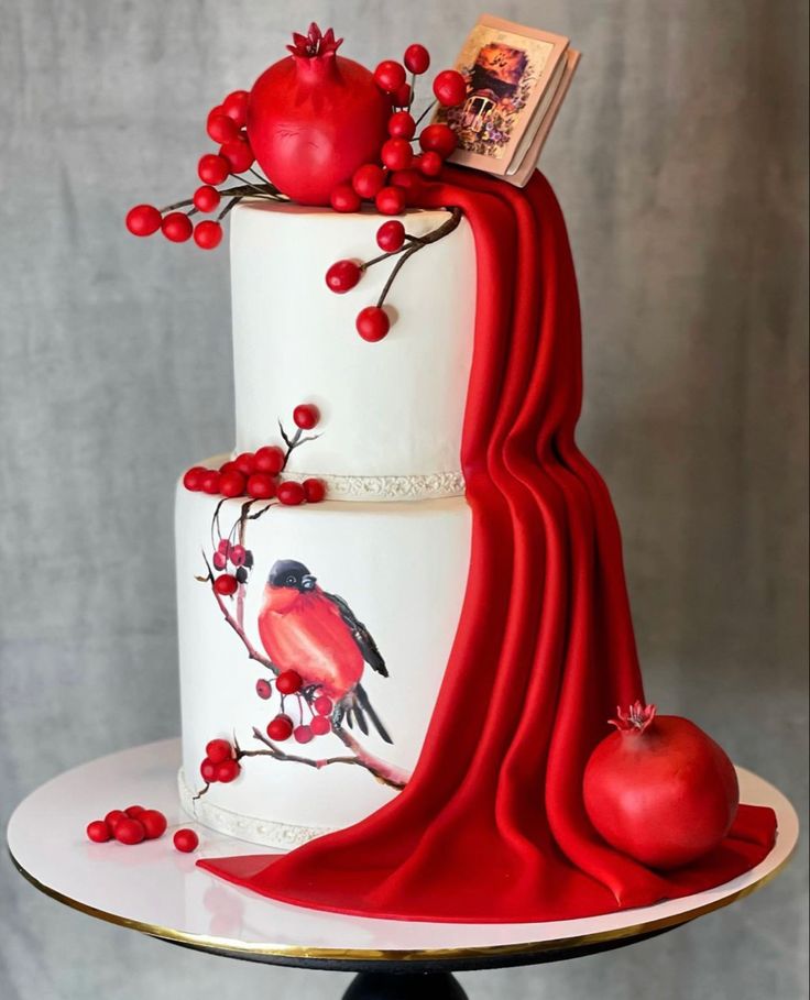 a three tiered cake decorated with red berries and an apple sits on a plate