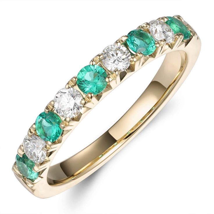 a gold ring with green and white stones