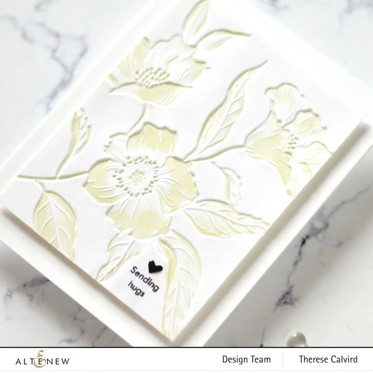 a white card with yellow flowers on it