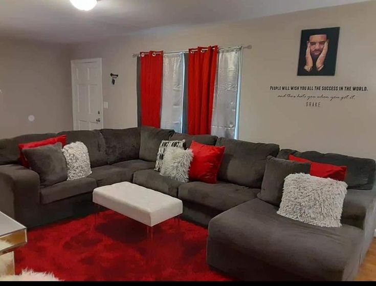 a living room with red and gray furniture