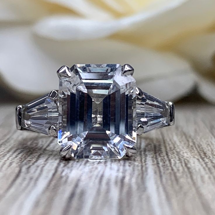 🐕 Big deals! Emerald Cut Moissanite Engagement Ring, Emerald Cut White Sapphire Wedding Ring For Ladies , April Birthstone Ring 14k White Gold, #6660 only at $685.00 Hurry. #MoissaniteRing #6639 #BirthdayGift #InfinityJewelers #AnniversaryGift #AprilBirthstone #6660 #WhiteSapphireRing #EmeraldCut #LadiesWeddingRing Baguette Cut Moissanite For Promise Rings, White Topaz Baguette Cut Ring With Center Stone, Cubic Zirconia Sapphire Ring Radiant Cut, Moissanite Diamond Ring With Baguette Cut Center Stone, Moissanite Diamond Ring With Center Stone Baguette Cut, Baguette Cut White Topaz Ring With Center Stone, Baguette Cut Moissanite Promise Ring, Emerald Ring Brilliant Cut Baguette For Promise, Emerald Ring With Diamond And Baguette Cut Cubic Zirconia