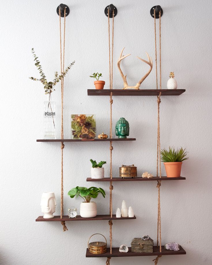 hanging shelves with plants and vases on them