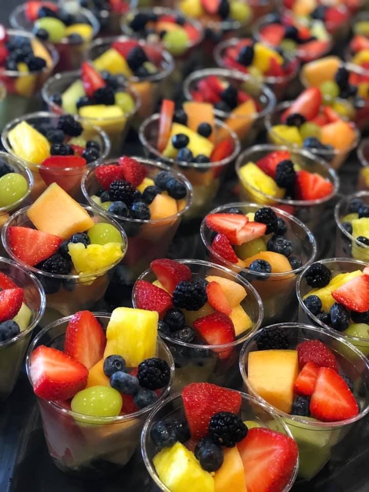 small cups filled with fruit on top of a table