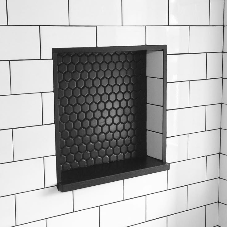 a black and white photo of a hexagonal pattern on a wall in a bathroom