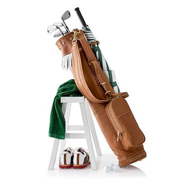 a golf bag sitting on top of a white stool next to a pair of shoes