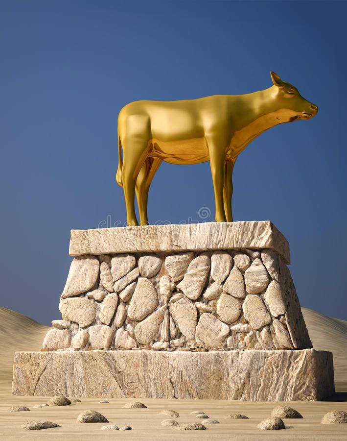 a golden cow statue on top of a rock formation in the desert, against a blue sky