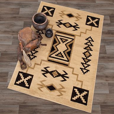 an area rug on the floor with a vase and other items in front of it