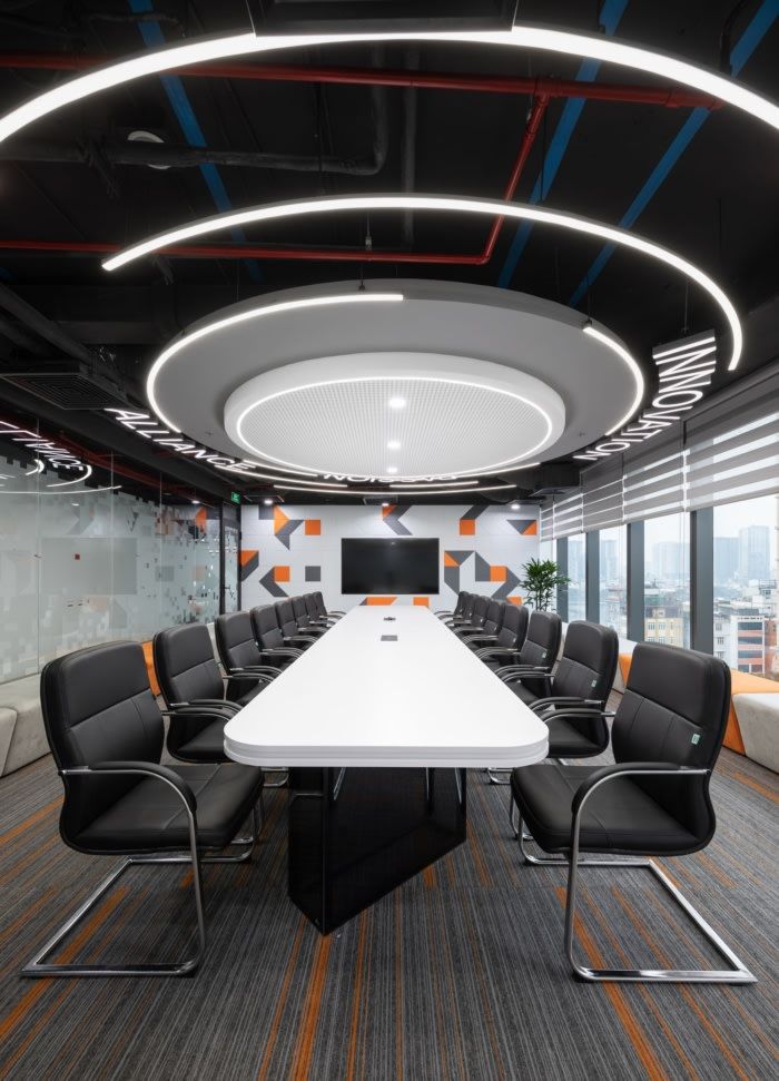 an empty conference room with chairs and a large white table in the middle of it