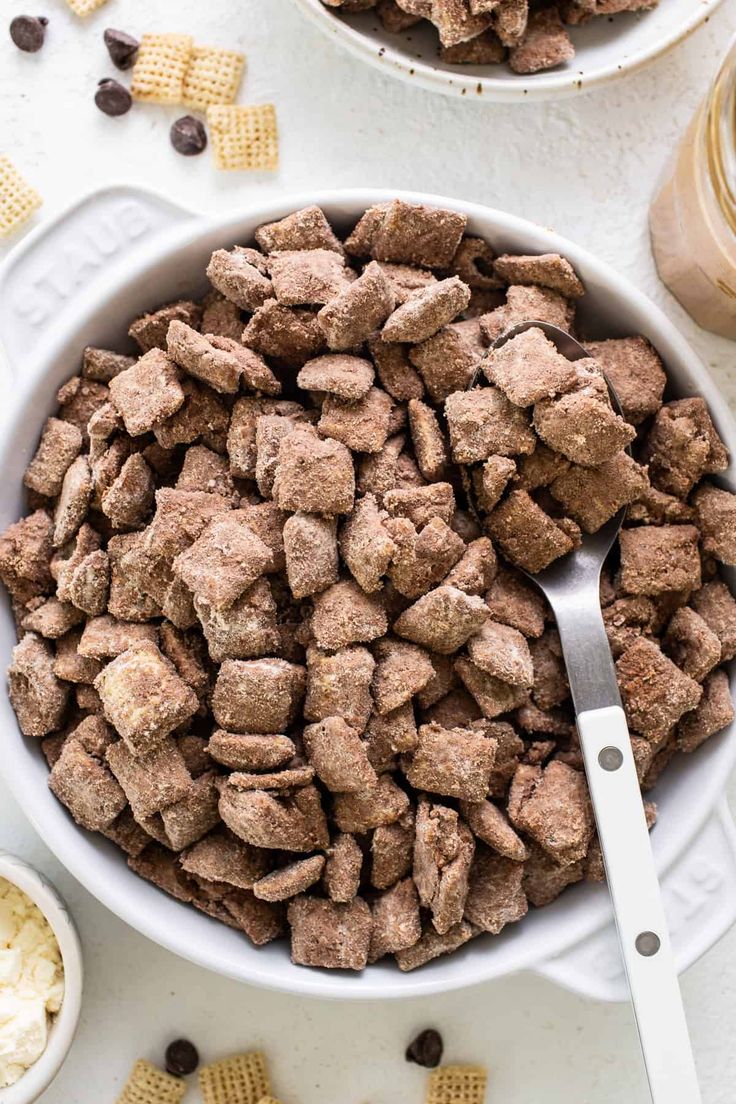 two bowls filled with dog food next to a bowl of corn chips and a glass of milk