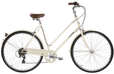 a white bicycle with brown seat and spokes on the front wheel, isolated against a white background