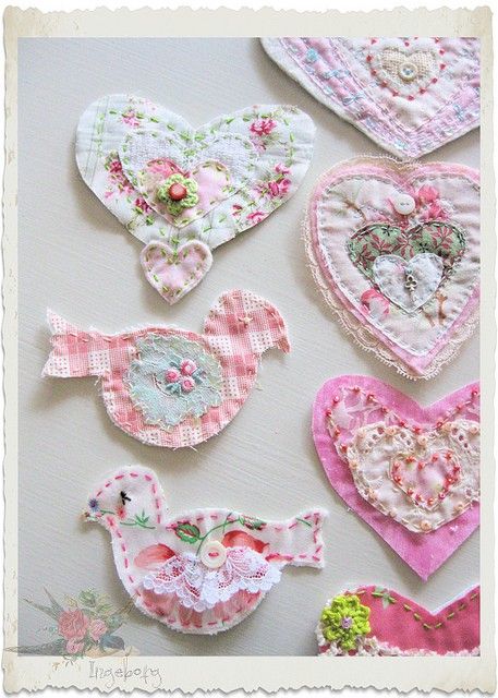 many different types of heart shaped appliques hanging on a wall