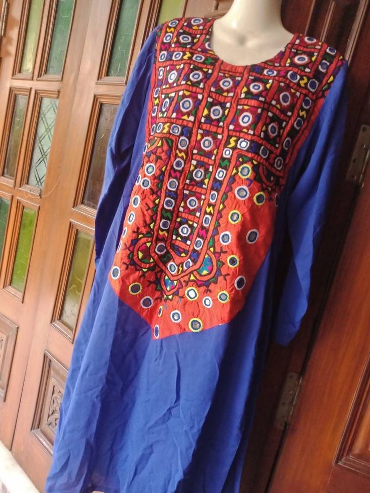 Beautiful afghan/pakistani light weight shirt.  Perfect for casual wear . Made with great care and love.  👉Dress material :linen 👉Dress Description : √Mirror work and thread hand work patch on neckline. √ Dress doesn't comes with pants and scarf.  👉Measurements : √ Bust: fits all upto 40 inches on both sides. 20 inches on 1 side. √ Length: 44 inches WE DO NOT SHIP TO A FEW COUNTRIES INCLUDING INDIA DUE TO CUSTOM ISSUES OF THE RESPECTIVE COUNTRIES SO PLEASE CHECK YOUR COUNTRY WITH US BEFORE PU Long Sleeve Kurta With Mirror Work For Eid, Long Sleeve Kurta With Mirror Work For Festivals, Bohemian Kurta With Mirror Work For Eid, Unstitched Bohemian Kurta With Mirror Work, Long Sleeve Kaftan With Mirror Work For Diwali, Navratri Traditional Wear With Long Sleeves And Dabka Work, Unstitched Long Sleeve Kurta With Mirror Work, Traditional Multicolor Tunic For Eid, Blue Cotton Kurta With Mirror Work