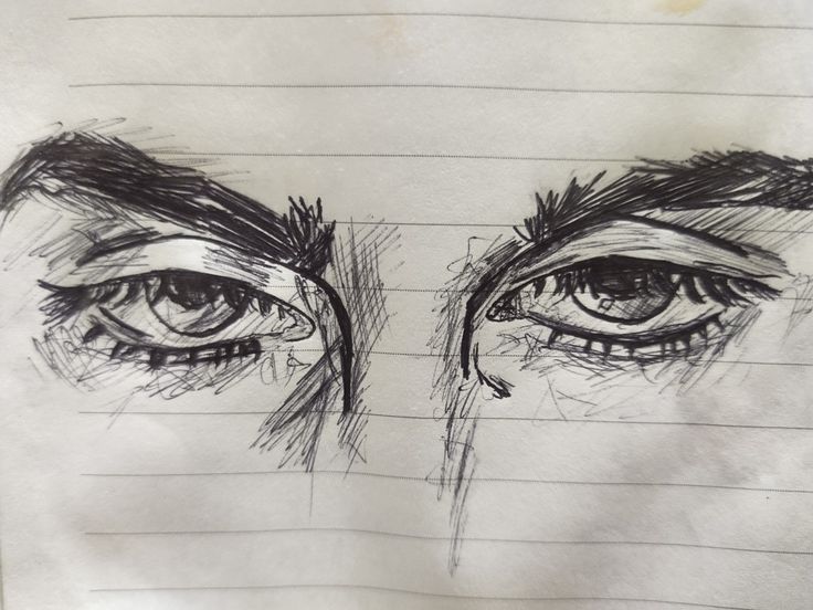 a drawing of two eyes with lines on paper behind them that are drawn in pencil