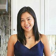 a woman in a blue dress standing in a kitchen