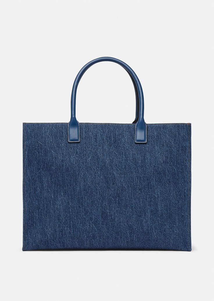 Crafted from denim canvas with leather top handles, this shopper bag is adorned with a Medusa plaque and raised logo lettering. The roomy interior has a large zipped pocket and protector strap, and the D-ring provides an optional attachment for a keyring or charm. Luxury Tote Bags, Suit Bag, Denim Tote Bags, Denim Tote, Handbag Shoes, Shopper Bag, Large Tote Bag, Leather Items, D Ring