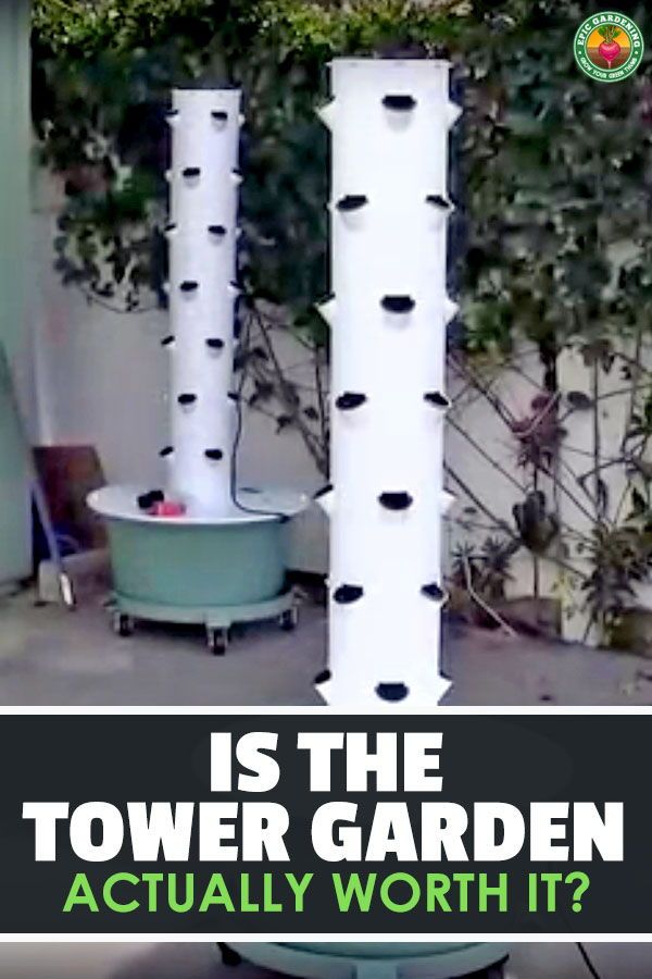 two tall white poles with holes on them in front of a building and an advertisement that says is the tower garden actually worth it?