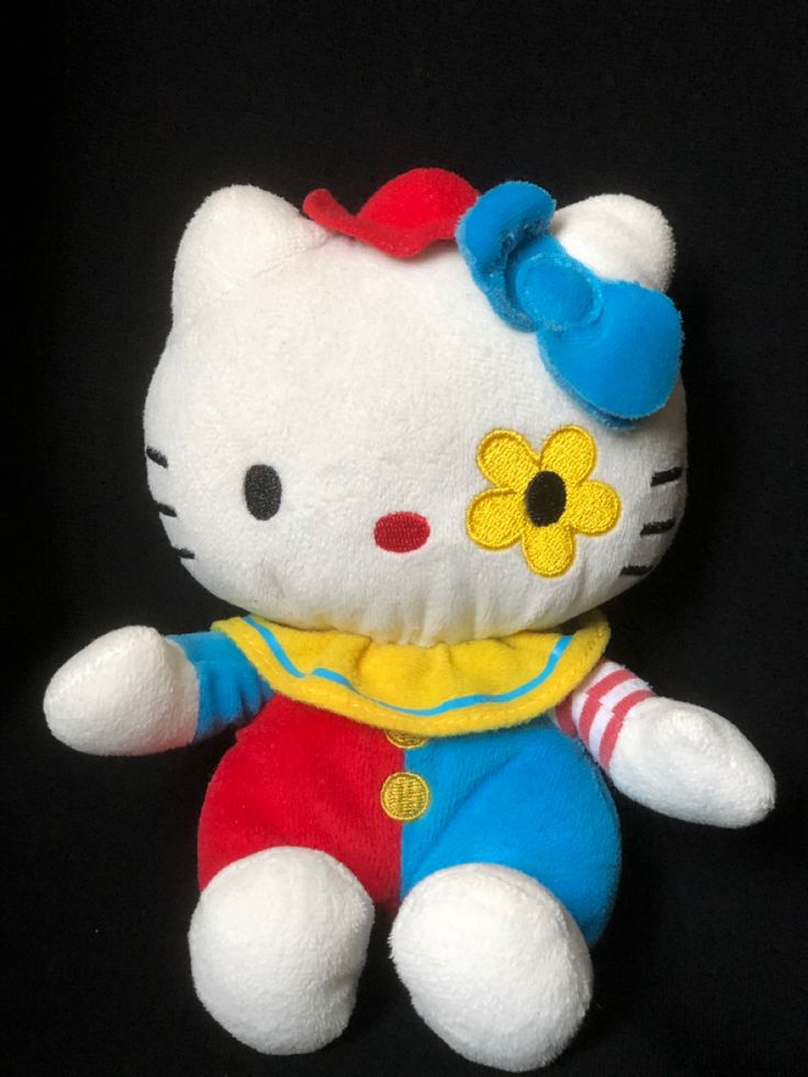 a hello kitty stuffed animal with a yellow flower on it's head